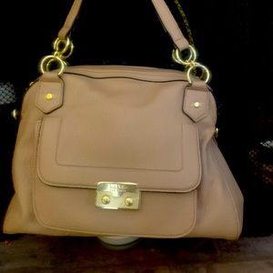 Cream colored purse with gold hardware